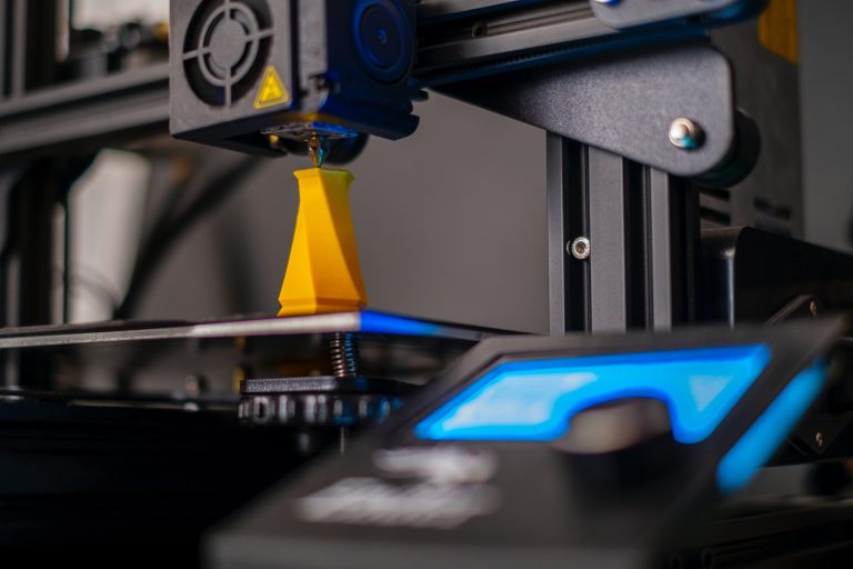 3D printer printing yellow object