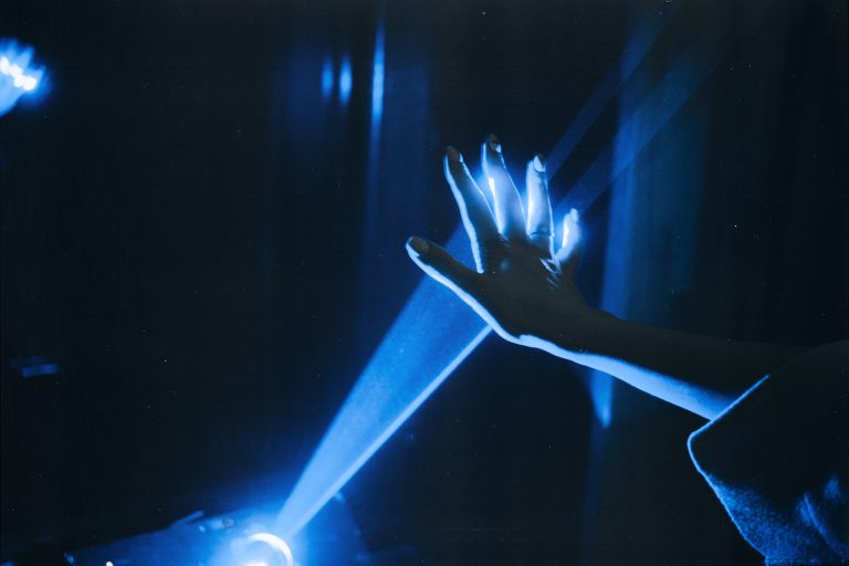 Photo of Person's Hand With Blue Light