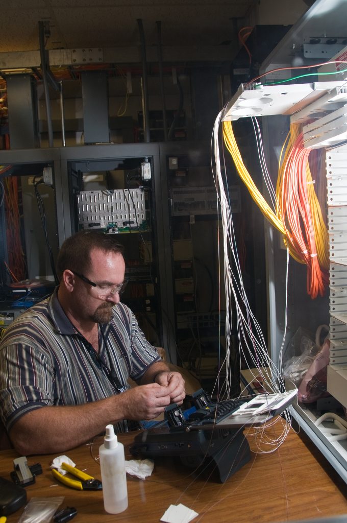 Man working with fiber optic cables