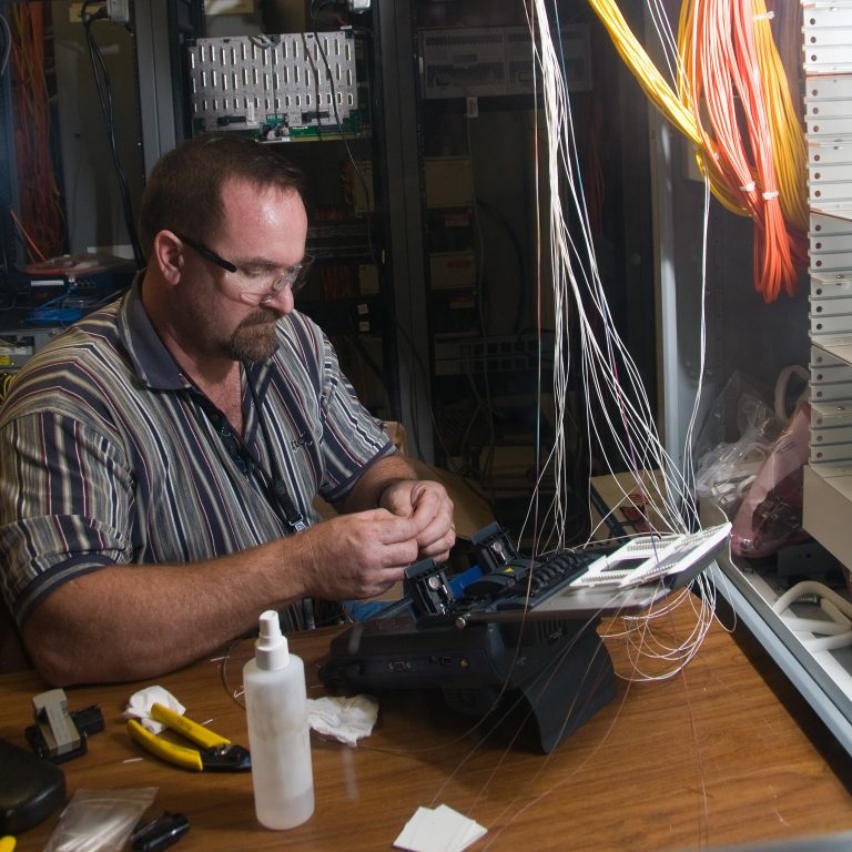 Man working with fiber optic cables